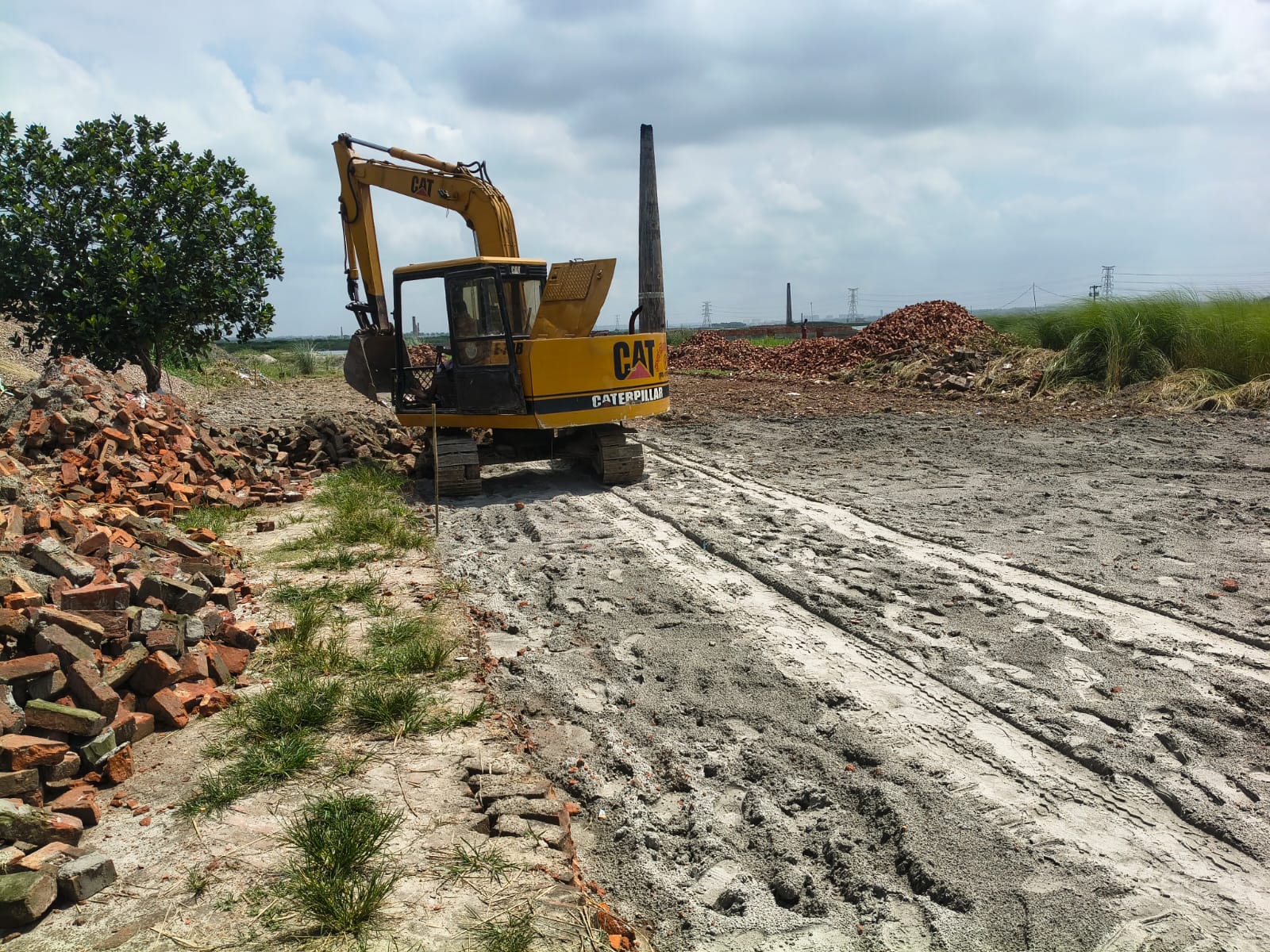 CAT excavator loading bricks